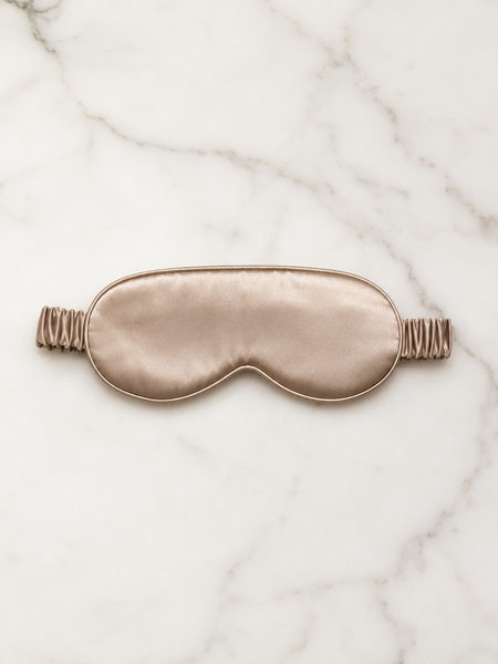 100% mulberry silk sleep mask in the color champagne. Luxury travel and sleep.