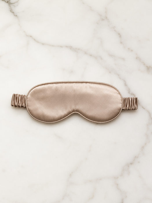100% mulberry silk sleep mask in the color champagne. Luxury travel and sleep.