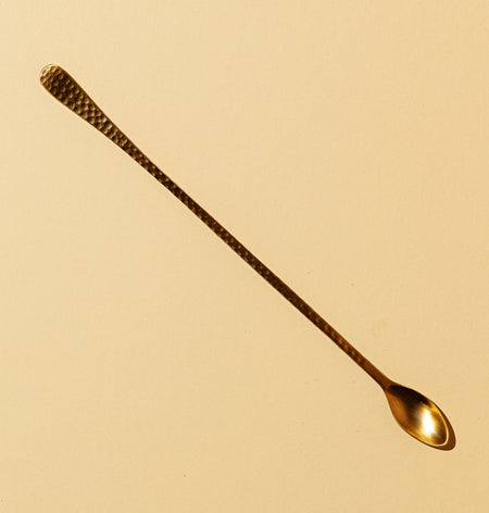 Long spoon in hammered brass for cocktails and drink mixing