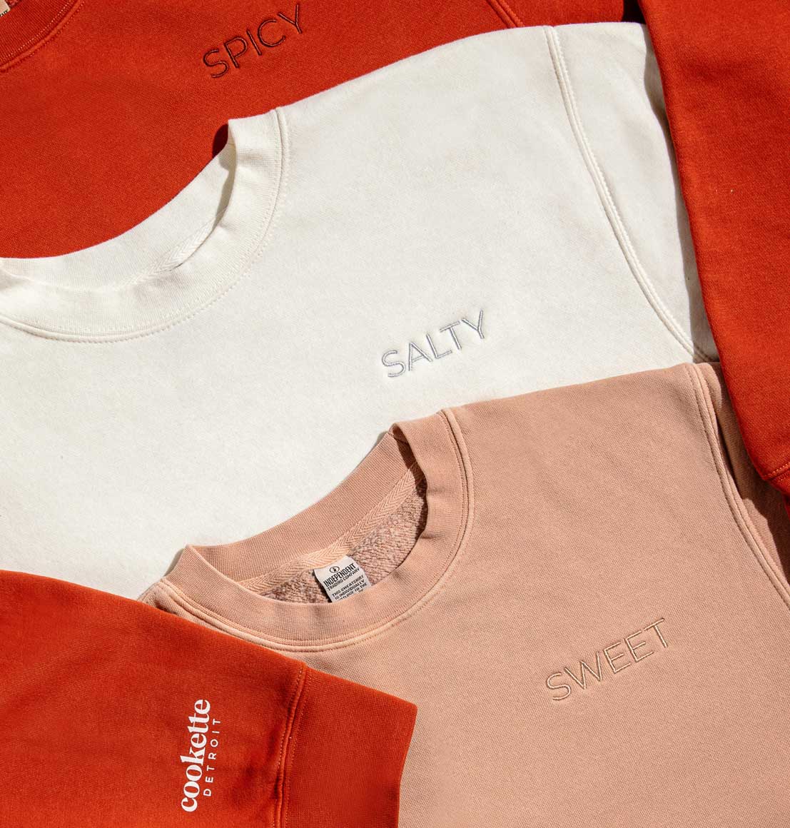 All three flavor mood sweatshirts layered together: Spicy, Salty, Sweet