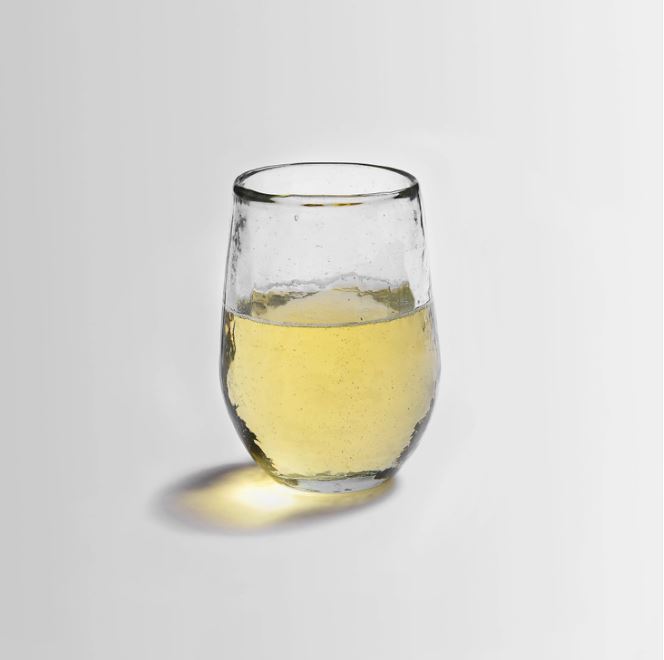 Thick, clear glassware brings something fresh to the table with its softly hammered texture. This small glass is the perfect size for casual imbibing.